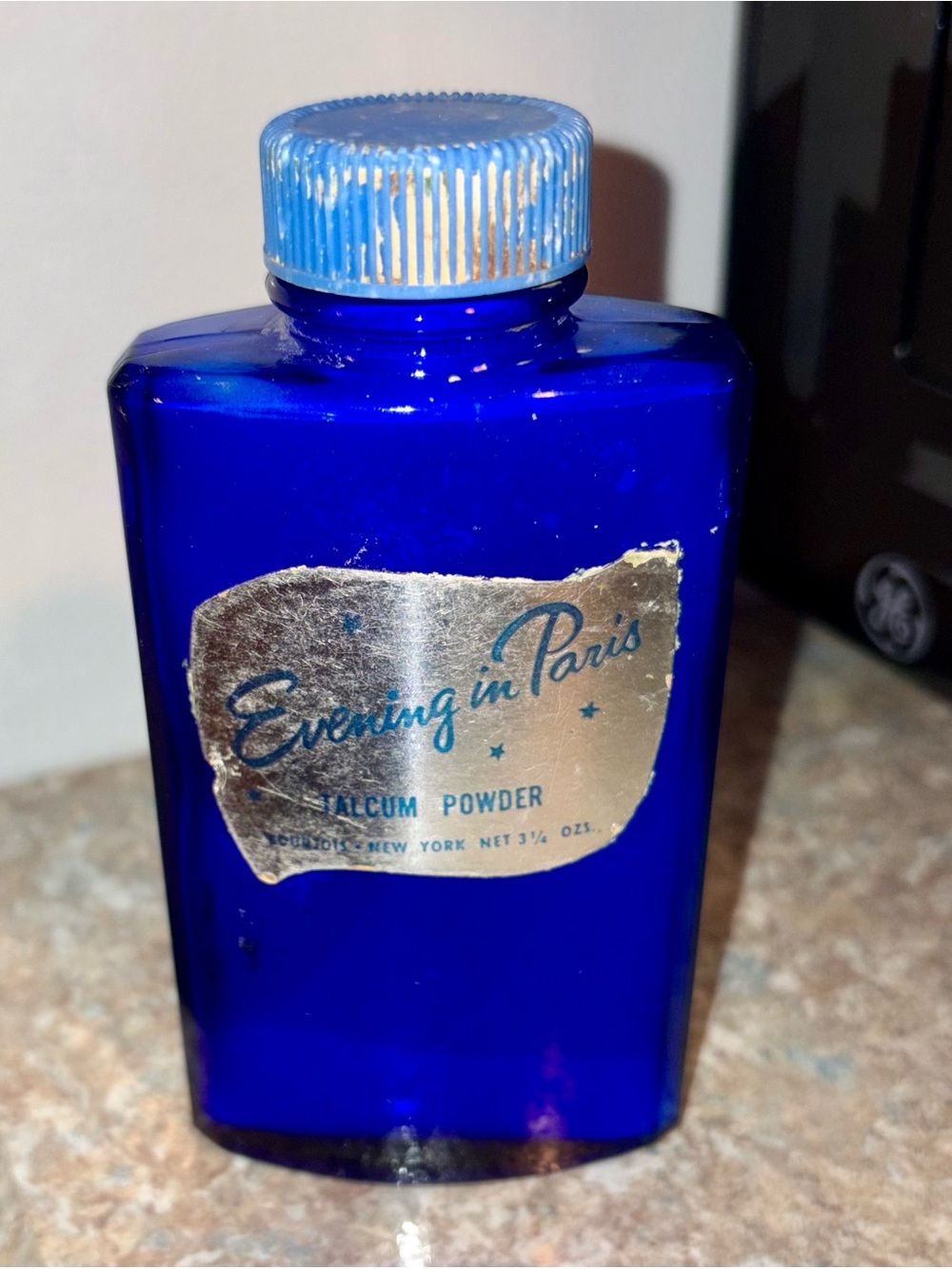 Vintage EVENING IN PARIS Blue Glass Bottle TALCUM POWDER 1/4 full